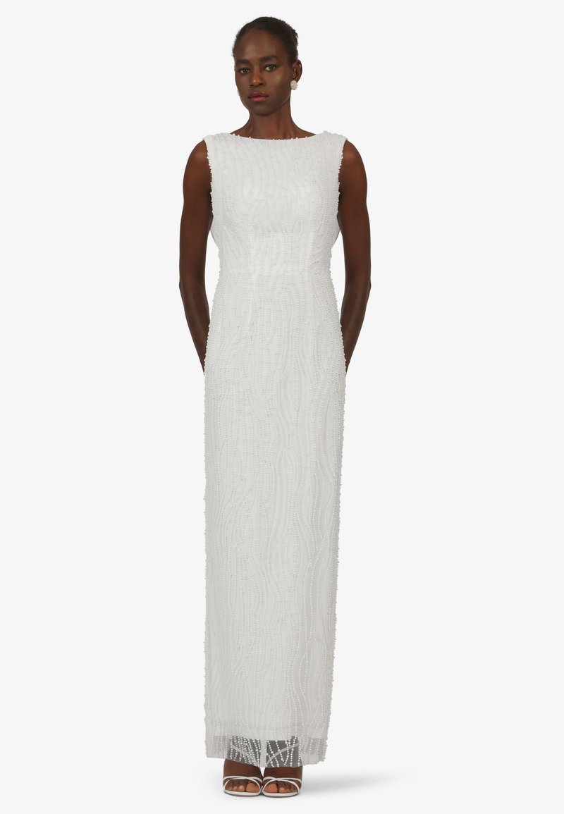 Long white dress featuring intricate bead detailing and a wavy texture, with a boat neckline and a straight silhouette.
