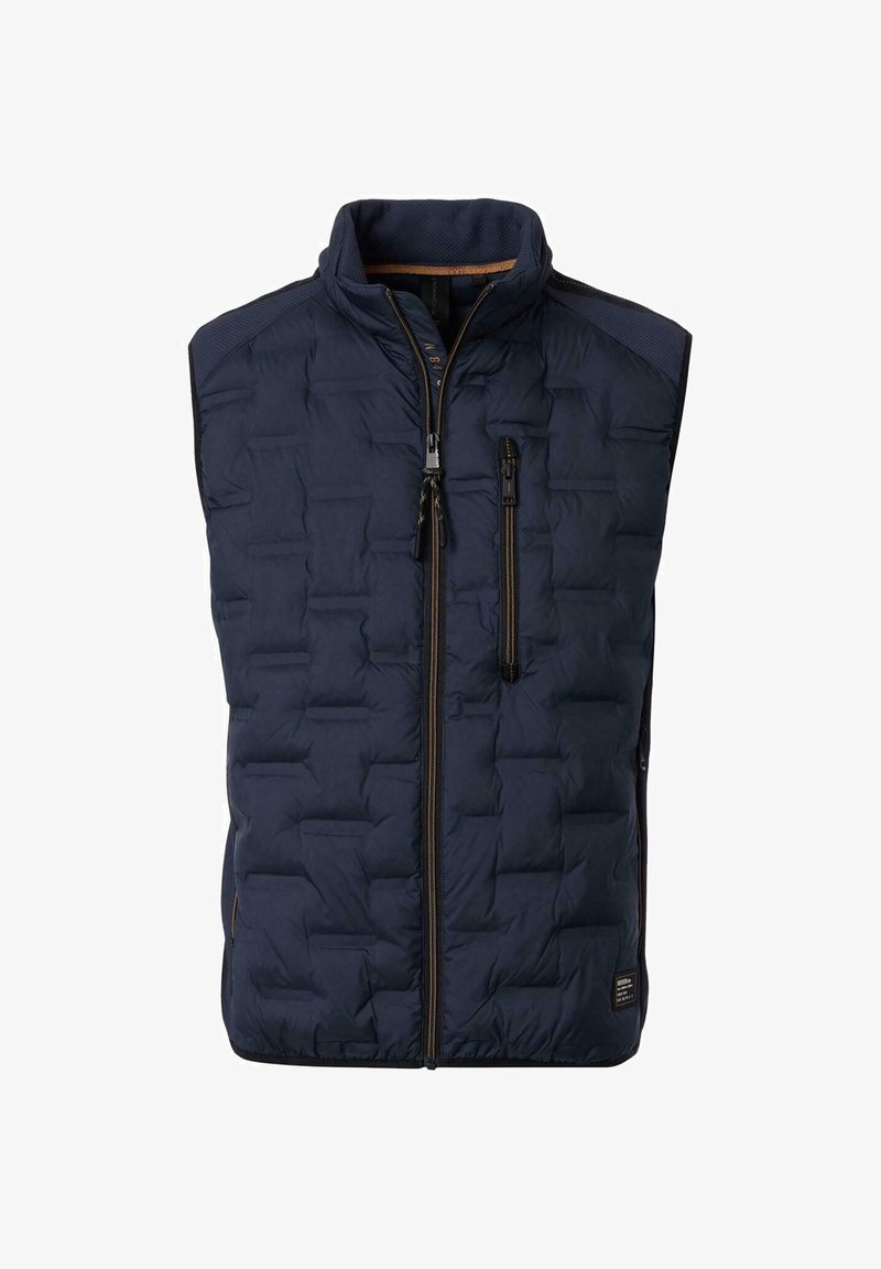 Laivasto sininen puhviliivi korkealla kauluksella, vetoketjulla ja sivutaskuilla. Omaleimainen kuviointitekstuuri ja kontrastiväriset ruskeat vetoketjuakcentit.