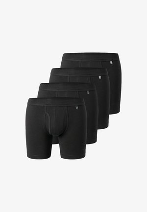 Boxer aderenti neri in cotone, con sacchetto foderato, elastico in vita e cuciture laterali senza soluzione di continuità. Quattro paia mostrati.