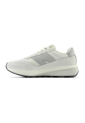 White sneaker with gray accents, featuring a textured mesh upper, flat laces, and a slightly elevated rubber sole for traction.