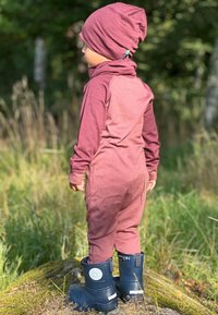 Maroon one-piece outfit with long sleeves, matching beanie, and blue rubber boots. Smooth texture, fitted design, and visible logo on boots.
