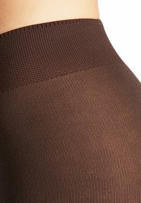 Collant marroni a coste con una vita strutturata, caratterizzati da una finitura liscia e un motivo a maglia uniforme su tutta la superficie.