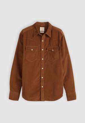 Brown corduroy shirt with long sleeves, pointed collar, two chest pockets, white buttons, textured fabric, and western-style yoke detailing.