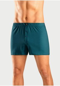 Teal moške bokserice so izdelane iz mehke tkanine, imajo elastičen pas, dve sprednji gumbki in klasičen design z udobnim krojem.