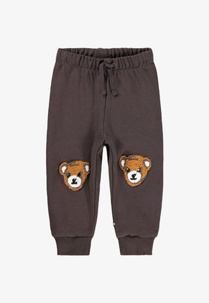 Joggers in cotone marrone scuro con vita elastica e cordino, caratterizzati da due volti di orso ricamati sulle ginocchia. Polsini a costine alle caviglie.