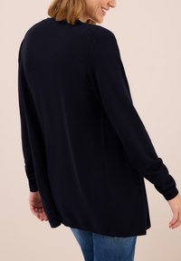 Marineblauer Langarm-Pullover mit lockerer Passform, gerippten Manschetten und abgerundetem Saum, aus weichem Strickmaterial hergestellt.