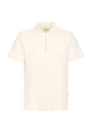 Polo à manches courtes de couleur crème avec une fermeture éclair à l'avant et un col classique, présenté sur un fond blanc uni.