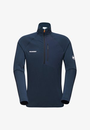 Pull bleu marin Mammut avec col montant, demi-zip et poche avant. Tissu texturé et panneau contrastant sur la poitrine.