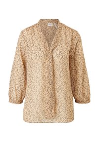 Blouse beige à manches longues avec motif abstrait noir, col en V avec détail noué, et poignets froncés aux manches.