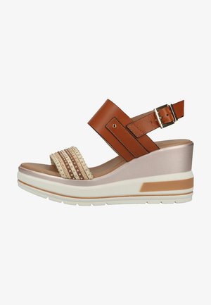 Wedge sandal featuring a brown leather ankle strap with buckle, a textured beige band, and a white platform sole with brown accents.