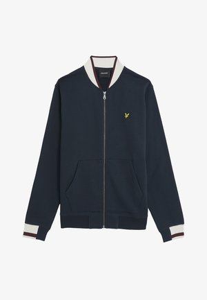 Navy zip-up jacket made of soft fabric, featuring a cream and maroon striped collar, two front pockets, and a small yellow emblem on the chest.