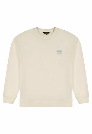 Bluza w kolorze kremowym z długimi rękawami, ściągaczami na mankietach i dole. Na lewej stronie klatki piersiowej znajduje się małe niebieskie logo. Miękka tekstura tkaniny.