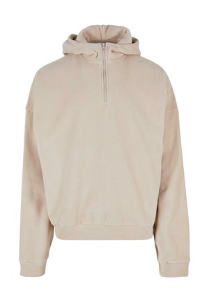 Beige hættetrøje med halvlynlås foran, løs pasform og ribbede manchetter. Fremstillet af blødt, tekstureret stof med et minimalistisk design.