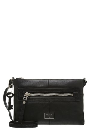 Black Fossil leather crossbody bag with silver zipper pocket, adjustable strap, and key-shaped metal charm on side chain.