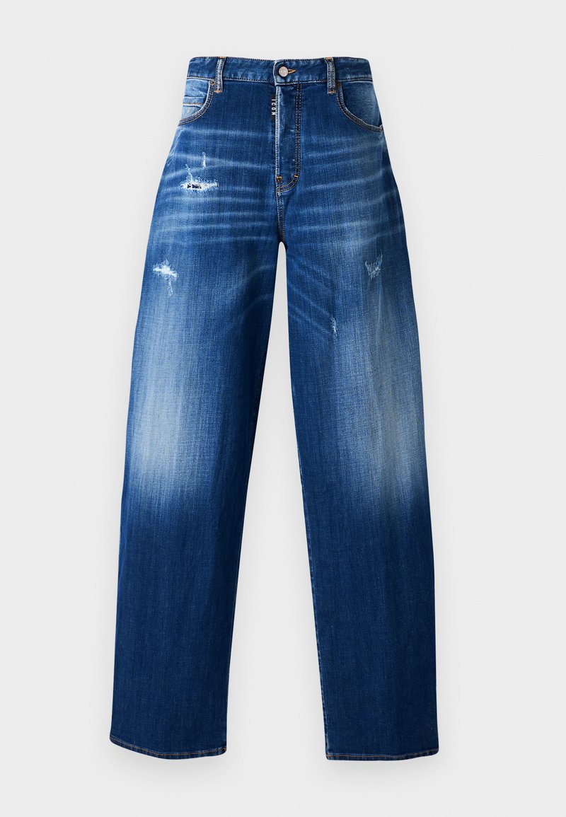 Vihreät siniset farkut, joissa on löysä istuvuus, haalistuneet alueet, näkyvät ompeleet ja hienovaraiset repeämät edessä ja takana.