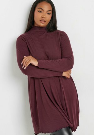 Long-sleeve ribbed dress in deep burgundy with a high neck and ruffled hem. Features a loose fit and soft, textured fabric.