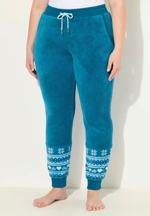 Pantalones de lounge de felpa en color verde azulado con puños blancos estampados, que presentan copos de nieve y corazones. Cintura ajustable con cordón y bolsillos laterales. Textura suave.