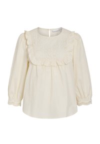 Blouse en coton crème avec un col volanté orné de broderies, manches longues avec des poignets élastiques et une fermeture à boutons au dos.