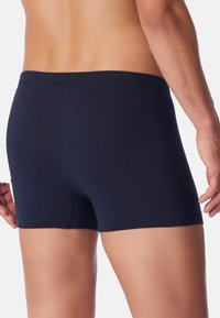 Boxer shorts in cotone blu navy con un design aderente, dotati di una vita elasticizzata e una texture liscia. Nessun logo o motivo visibile.