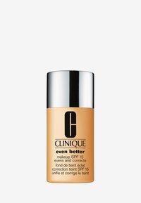 Flacon de fond de teint Clinique Even Better, liquide beige, forme cylindrique, capuchon argenté, étiquette avec le nom de la marque et les détails SPF 15.
