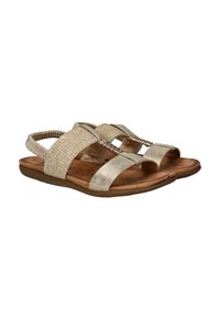 Sandales pour femmes beige et doré clair avec des sangles arrière élastiques, une semelle rembourrée et des spirales métalliques décoratives sur les sangles en tissu.