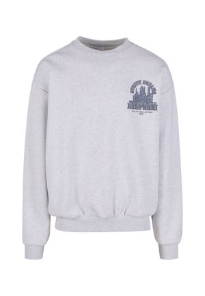 Svetlosivá mikina s rebrovanými manžetami a lemom. Na hrudi je grafická potlač s textom "KARL KANI" a dizajnom panorámy mesta.