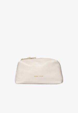 Weiche beige Marc Ellis Tasche mit goldenem Reißverschluss und goldenem Logo-Schriftzug in der Mitte vorne.