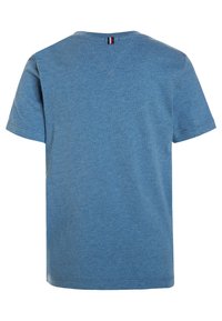 Lyseblå T-skjorte laget av myk stoff, med klassisk rund hals og korte ermer. Bakdetaljen inkluderer et lite logo-klaff.