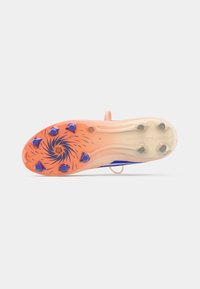 Suela de zapato con un patrón en espiral, secciones naranja y translúcidas, ocho clavos azules y un punto de sujeción central.