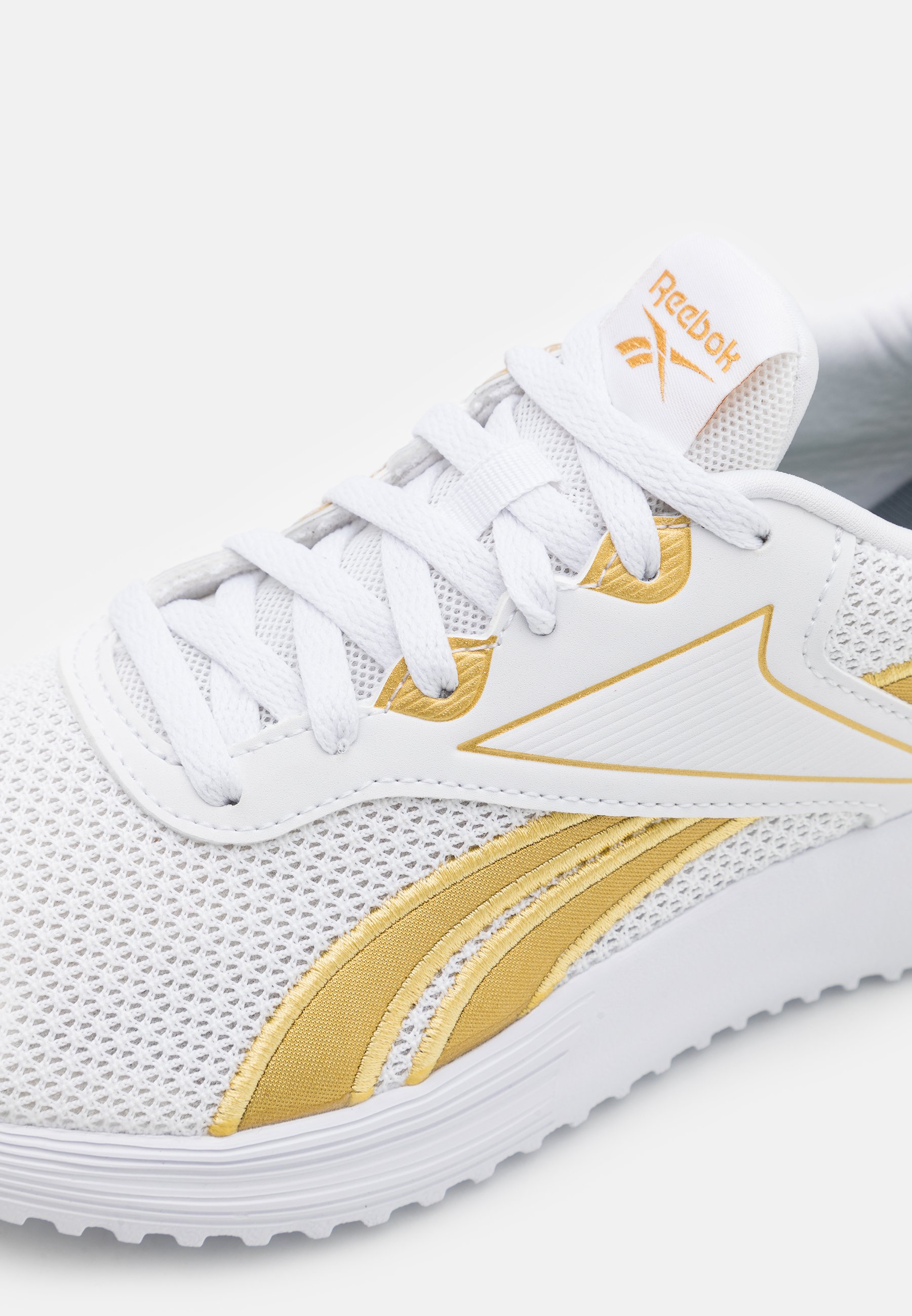 white and gold running shoes