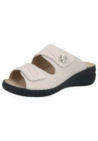 White textured slide sandal with two adjustable straps and a black wedge sole. Features a decorative button on one strap.