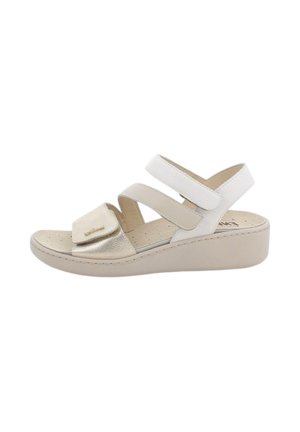 Sandalo beige con zeppa, tre cinturini regolabili in velcro e soletta imbottita traforata per comfort e supporto.