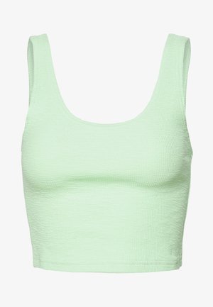 Haut court en tissu texturé vert clair avec de larges bretelles et un décolleté carré.