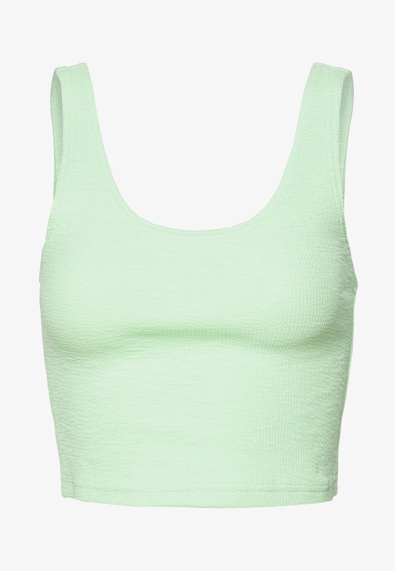 Haut court en tissu texturé vert clair avec de larges bretelles et un décolleté carré.