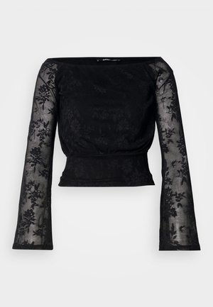 Μαύρη δαντελένια μπλούζα με μακριά, φουσκωτά μανίκια. Διαθέτει λουλουδάτο σχέδιο και εφαρμοστό μέσο, φτιαγμένη από διάφανο, υφασμένο ύφασμα.