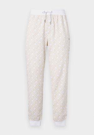 White jogger pants with beige geometric pattern, elastic waistband with white drawstring, and white ankle cuffs.