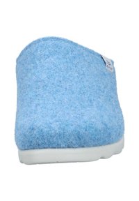 Blue felt clog with rounded design. Soft texture, white rubber sole, and small logo tag on the side. Features a minimalistic shape.