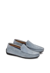 Light blue suede loafers with a flexible black rubber sole, featuring tonal stitching and a subtle brand logo on the side.