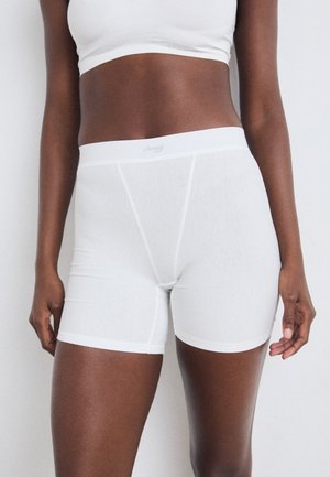 Hvite bomullsblandede boxer-shorts med en myk midjebånd, som har en lett glans og glatt tekstur. Logo trykt på midjebåndet.