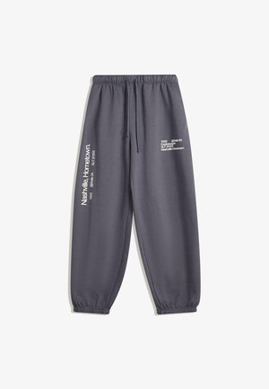 Pantaloni della tuta grigi con vita elastica e polsini, caratterizzati da una stampa a contrasto in bianco sulla gamba sinistra che esprime un design moderno.