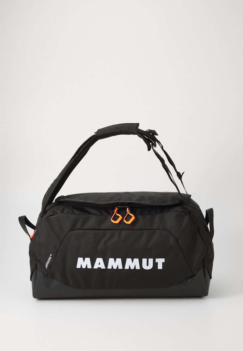Black duffle bag with orange zipper pulls. Features logo "MAMMUT" in white, padded handle, and fabric texture with a sturdy design.