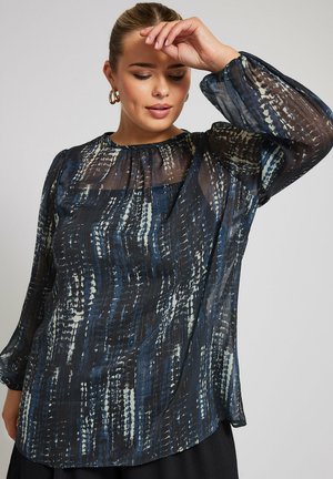 Sheer blouse featuring a navy and cream abstract pattern, long puffy sleeves, a rounded neckline, and a loose fit design.