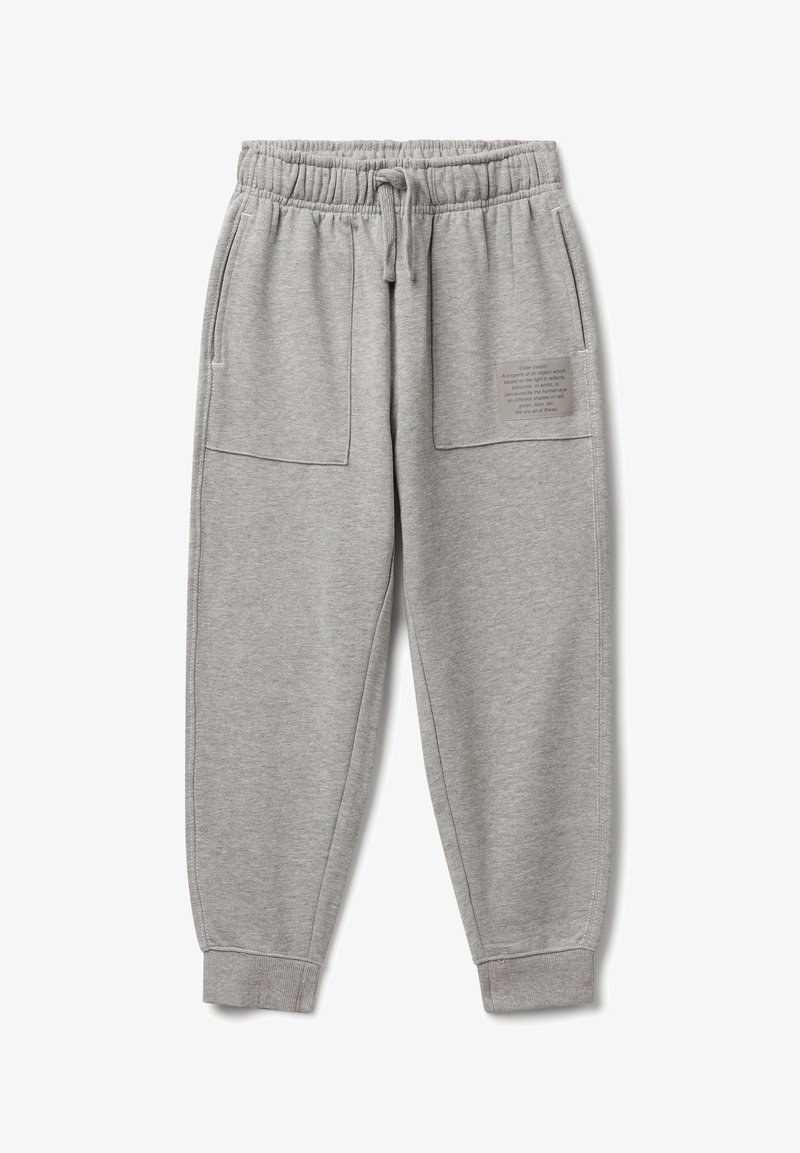 Světle šedé tepláky s elastickým pasem, šňůrkou, velkými předními kapsami, manžetami na kotnících a malou textovou nášivkou na pravé kapse.