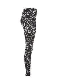 Svarta leggings med ett vitt leopardmönster, tillverkade av elastiskt tyg med en smooth yta. Högmidjad design.