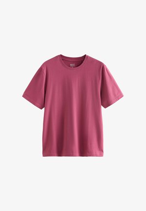 Puuvillast t-särk ühtlases tumeroosas toonis, millel on ümmargune kaelus ja lühikesed varrukad, lõdva lõikega ning ilma nähtavate mustriteta.