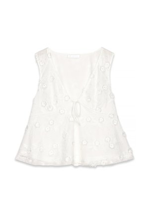 Vit ärmlös topp med djup V-ringning, blommig broderi, mjuk textur, en knytning framtill och en utsvängd nederdel.
