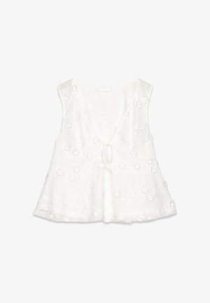 Top sans manches blanc avec un décolleté en V profond, broderies florales, texture douce, un détail à nouer à l'avant et ourlet évasé.