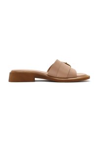 Beige leather slide sandal with a square toe and two overlapping straps, featuring a low, brown block heel. Smooth texture and minimal design.