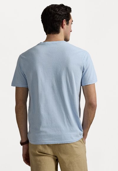 Light blue cotton t-shirt with short sleeves and a crew neckline, featuring a smooth texture and a relaxed fit, viewed from the back.