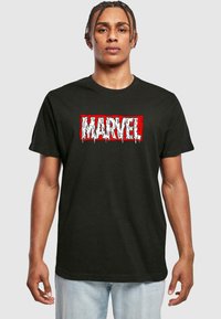 Black cotton t-shirt featuring a textured white and red "MARVEL" logo with dripping details, crew neck design, and short sleeves.